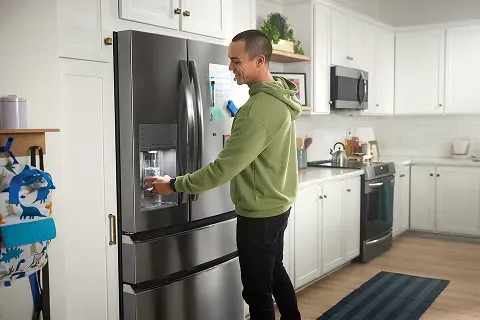 man-using-water-dispenser